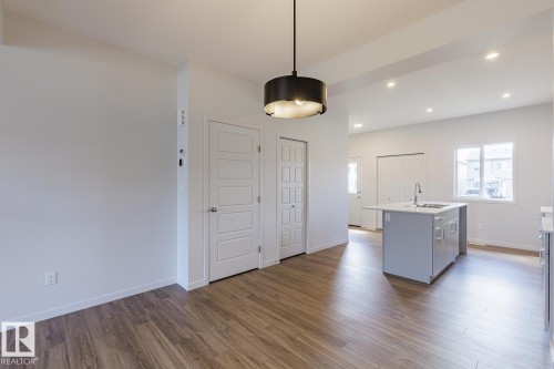 Spacious interior featuring wood-finish flooring and recessed ceiling lights - 3619 Triomphe Boulevard, Beaumont, AB - Indoor
