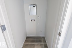 Dedicated laundry alcove featuring tile flooring, white walls, and hookups for appliances - 
