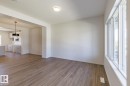 Spacious interior featuring wood-finish flooring, white walls, and a recessed ceiling light fixture - 3619 Triomphe Boulevard, Beaumont, AB  - Indoor Photo Showing Other Room 
