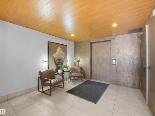 Entry area featuring a wood-finish ceiling, recessed lighting, and light-toned tile flooring - #207 10606 102 Av Nw, Edmonton, AB 