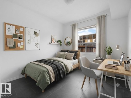 Bedroom featuring dark tile flooring, a window with natural light, and clean white walls - #207 10606 102 Av Nw, Edmonton, AB 