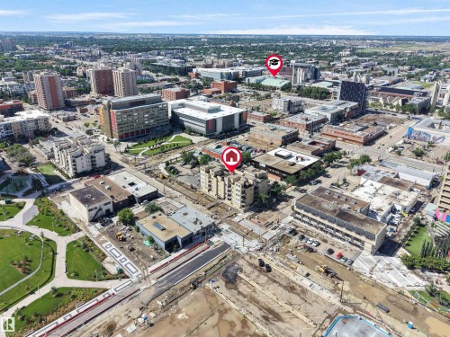 Urban aerial perspective showcasing a multi-story building within a dense city environment - #207 10606 102 Av Nw, Edmonton, AB 