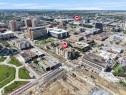 Urban aerial perspective showcasing a multi-story building within a dense city environment - #207 10606 102 Av Nw, Edmonton, AB 