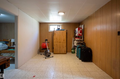 Finished lower level space featuring paneling walls and tile flooring - 10428 68 Avenue Nw, Edmonton, AB - Indoor Photo Showing Other Room