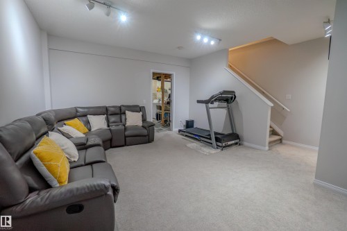 Spacious lower-level area with light-toned carpet flooring and neutral wall tones - 1766 Dumont Crescent Sw, Edmonton, AB 