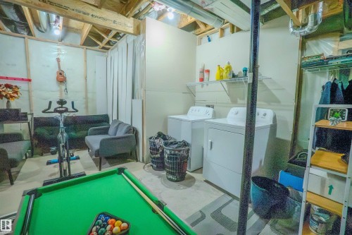 Unfinished basement offering flexible potential with exposed ceiling joists and visible ductwork - 1766 Dumont Crescent Sw, Edmonton, AB 