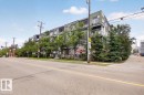 Contemporary multi-story building featuring a facade combining grey paneling and stone cladding - #406 8525 91 St Nw, Edmonton, AB 
