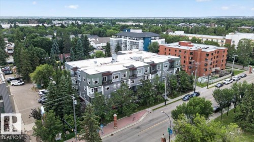 Modern residential building with a flat roof and multiple balconies - #406 8525 91 St Nw, Edmonton, AB 