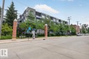 Modern multi-story building featuring a facade of grey paneling and stone accents - #406 8525 91 St Nw, Edmonton, AB 