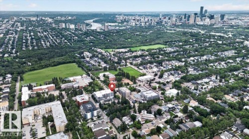Aerial perspective showcasing a residential neighborhood with a distant cityscape - #406 8525 91 St Nw, Edmonton, AB 