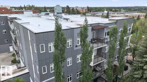 Modern multi-story building featuring grey panel siding and white window frames - #406 8525 91 St Nw, Edmonton, AB 