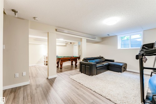 Finished lower level with recessed lighting, wood-finish flooring, a window, and painted walls - 5212 142 Street Nw, Edmonton, AB - Indoor