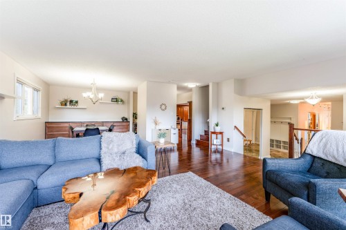 Open-concept living area featuring rich wood-finish flooring, recessed lighting, and a white ceiling - 5212 142 Street Nw, Edmonton, AB - Indoor Photo Showing Living Room