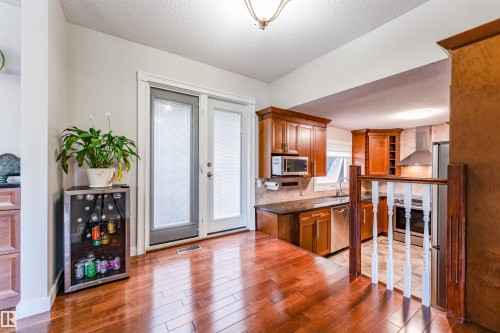 Hardwood flooring extending to double glass panel doors - 5212 142 Street Nw, Edmonton, AB - Indoor