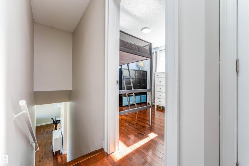 Hardwood-style flooring throughout both visible levels - 5212 142 Street Nw, Edmonton, AB - Indoor Photo Showing Other Room