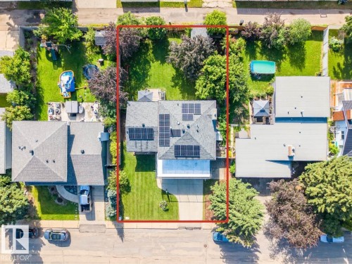 Aerial perspective showcasing a residential property with a large backyard and mature trees - 5212 142 Street Nw, Edmonton, AB - Outdoor With View