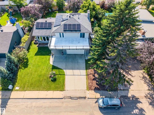Two-story residence featuring a front-facing garage and an upper-level balcony with a glass railing - 5212 142 Street Nw, Edmonton, AB - Outdoor