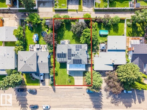 Aerial view showcasing a residential property with a gray shingle roof and multiple solar panels - 5212 142 Street Nw, Edmonton, AB - Outdoor With View