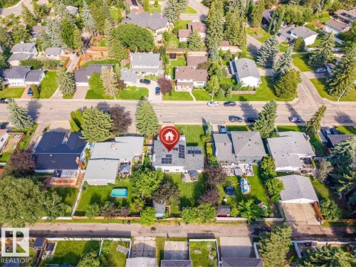 Aerial perspective showcasing a residential property with a detached home, mature landscaping, and an above-ground pool - 5212 142 Street Nw, Edmonton, AB - Outdoor With View