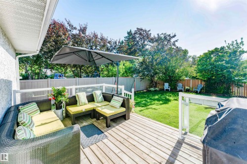 Expansive wood-plank deck with white railings and clear panels - 5212 142 Street Nw, Edmonton, AB - Outdoor With Deck Patio Veranda