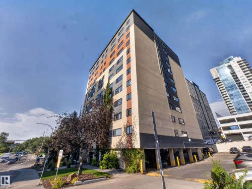 Multi-story building featuring a beige, black, and orange exterior facade - #502 9710 105 St Nw, Edmonton, AB 