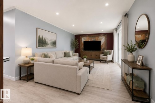 Open-concept living space with light wood-finish flooring - 27 Apache Crescent, Leduc, AB 