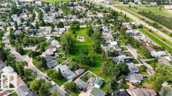 Aerial perspective of a residential neighborhood featuring numerous detached homes with varying roof styles - 
