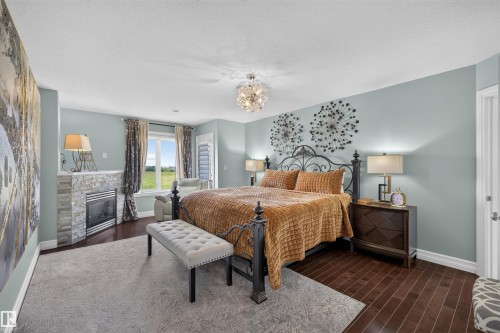 1751 Haswell Cove Nw, Edmonton, AB - Indoor Photo Showing Bedroom With Fireplace