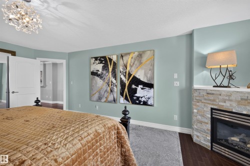 1751 Haswell Cove Nw, Edmonton, AB - Indoor Photo Showing Bedroom With Fireplace