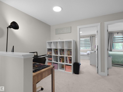 Open-concept space with light-colored carpeting and recessed ceiling lighting - #30 4137 76 St Nw, Edmonton, AB 