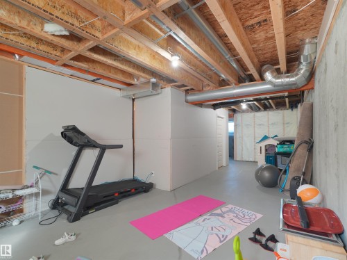 Unfinished basement space featuring exposed wood joists and visible ductwork - #30 4137 76 St Nw, Edmonton, AB 