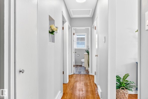 Hallway featuring wood-finish flooring, light gray walls, and white trim - 16152 110B Avenue Nw, Edmonton, AB - Indoor Photo Showing Other Room