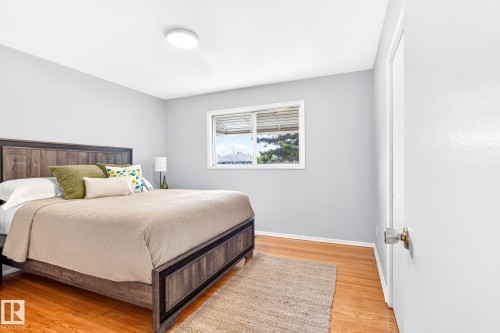 Hardwood-style flooring throughout the room with a bright window - 16152 110B Avenue Nw, Edmonton, AB - Indoor Photo Showing Bedroom