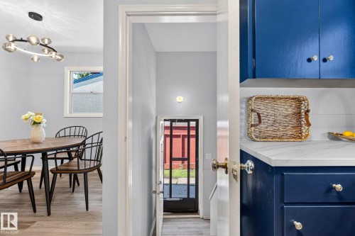 Kitchen featuring blue cabinetry, white countertop, and white subway tile backsplash - 16152 110B Avenue Nw, Edmonton, AB - Indoor