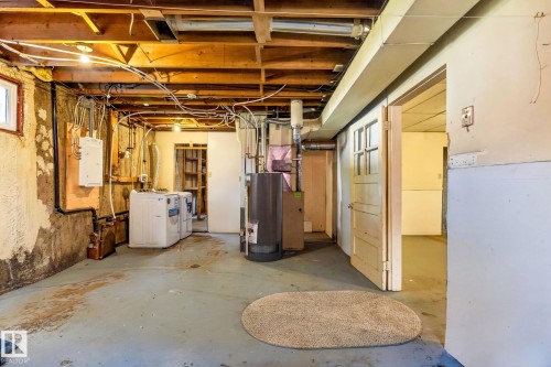Basement utility area featuring exposed wood joists, concrete flooring, and a window - 16152 110B Avenue Nw, Edmonton, AB - Indoor Photo Showing Basement