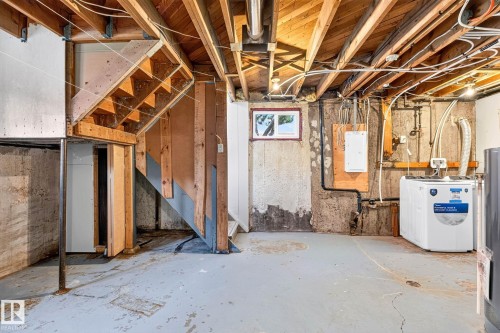 Unfinished lower level featuring exposed wood joists, a utility sink, and a concrete floor - 16152 110B Avenue Nw, Edmonton, AB - Indoor Photo Showing Basement