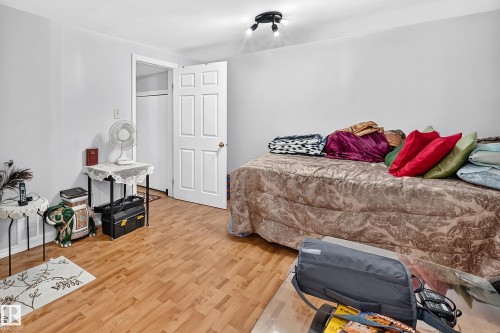 Room featuring light wood-finish flooring, white painted walls, and a white six-panel door - 243 Abbotsfield Road Nw, Edmonton, AB - Indoor Photo Showing Bedroom