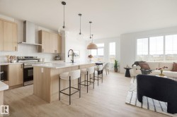 Open-concept living space with wood-finish flooring - 