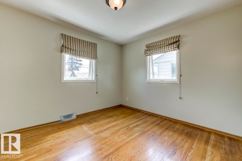 Hardwood flooring paired with light neutral walls - 8511 64 Avenue, Edmonton, AB - Indoor Photo Showing Other Room