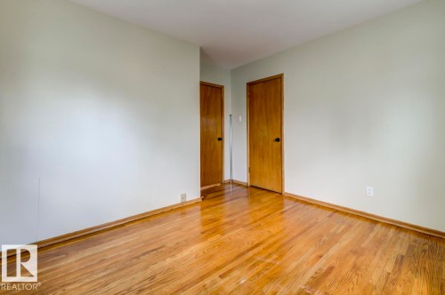Hardwood flooring featuring a high-gloss finish - 8511 64 Avenue, Edmonton, AB - Indoor Photo Showing Other Room
