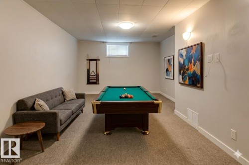 Recreation area featuring a billiard table, recessed window, and light-toned carpet flooring - 8511 64 Avenue, Edmonton, AB - Indoor Photo Showing Other Room