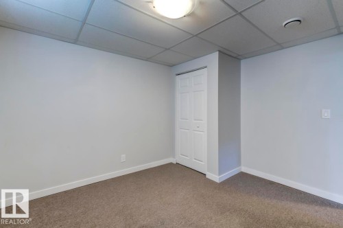 Neutral wall paint with carpeted flooring and white baseboards - 8511 64 Avenue, Edmonton, AB - Indoor Photo Showing Other Room