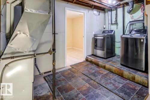 Basement utility area featuring a furnace, exposed ductwork, and plumbing - 8511 64 Avenue, Edmonton, AB - Indoor Photo Showing Laundry Room