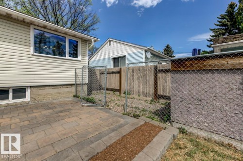 Paved patio area featuring interlocking pavers with a stone border - 8511 64 Avenue, Edmonton, AB - Outdoor
