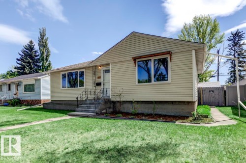 Single-story residence featuring light-colored horizontal siding, a gabled roofline, and a concrete foundation - 8511 64 Avenue, Edmonton, AB - Outdoor