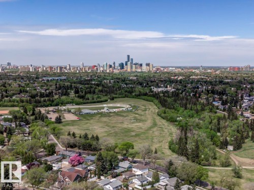 Aerial perspective showcasing a residential neighborhood with a distant city skyline - 8511 64 Avenue, Edmonton, AB - Outdoor With View