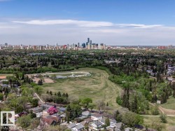 Aerial perspective showcasing a residential neighborhood with a distant city skyline - 