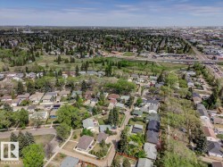 Expansive aerial perspective showcasing a residential area with varied housing styles and mature trees - 