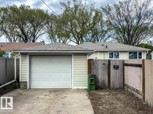 Single-car garage with an overhead door and concrete driveway - 8511 64 Avenue, Edmonton, AB - Outdoor With Exterior