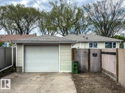 Single-car garage with an overhead door and concrete driveway - 